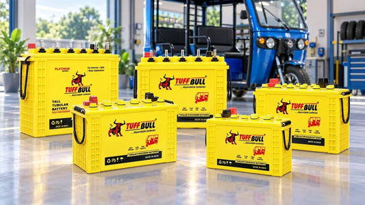 Range of Tuff Bull e-rickshaw batteries displayed with an electric rickshaw in a workshop
